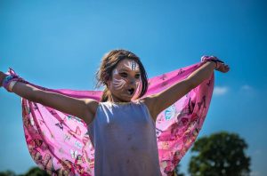 Girl with facepaint and cape