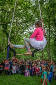 girl on trapeze, children watching