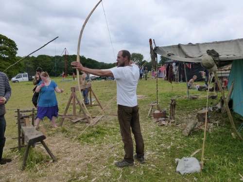 Man holding handmade wooden bow