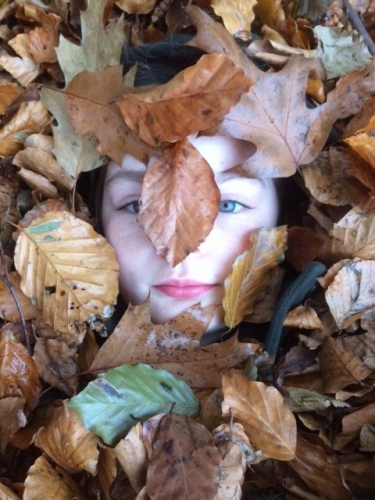 Child's face in leaves